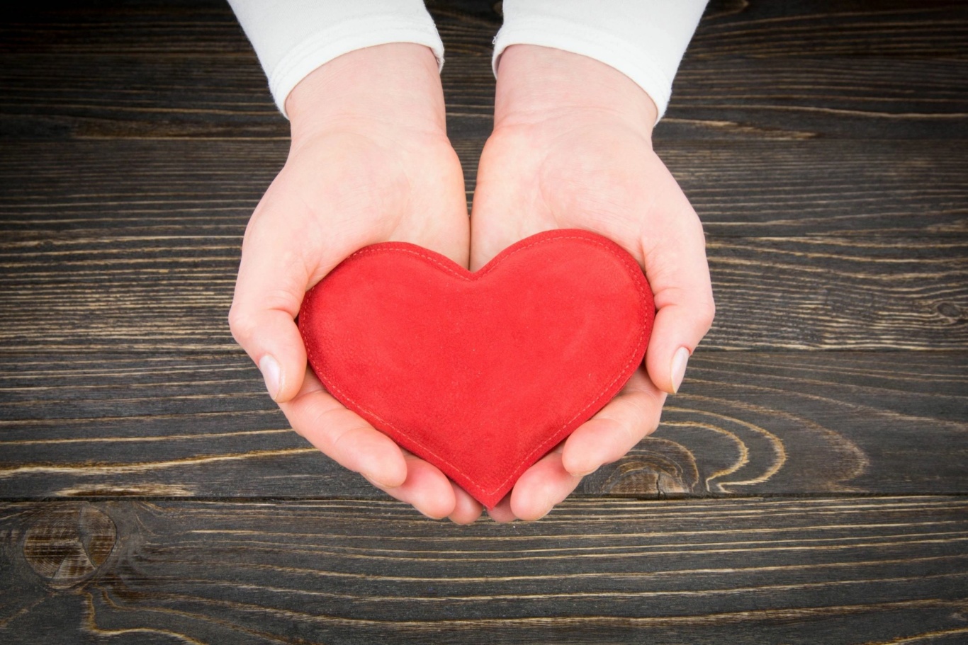 Person holding a red heart shape